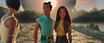 Movie still from “Raya and the Last Dragon” (2021), directed by Don Hall – A man and a woman standing next to each other in front of the sun; Medium shot, Over the shoulder angle