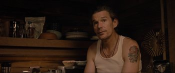 Movie still from “Raymond & Ray” (2022), directed by Rodrigo García – A man sitting in front of a bunch of plates; Close Up shot, Over the shoulder angle