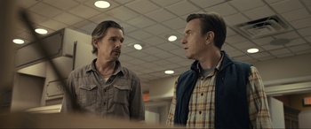 Movie still from “Raymond & Ray” (2022), directed by Rodrigo García – Two men standing next to each other in a room; Medium shot, Low angle