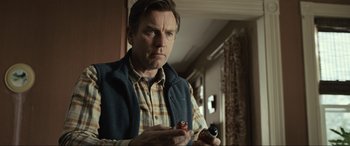 Movie still from “Raymond & Ray” (2022), directed by Rodrigo García – A man in a plaid shirt holding a cigarette; Close Up shot, Low angle