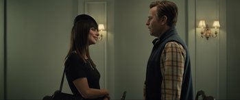 Movie still from “Raymond & Ray” (2022), directed by Rodrigo García – A man and a woman standing next to each other in a room; Medium shot, Over the shoulder angle