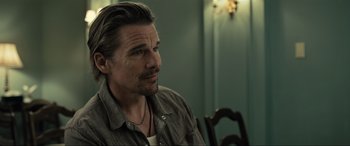 Movie still from “Raymond & Ray” (2022), directed by Rodrigo García – A person sitting at a table; Close Up shot, Over the shoulder angle