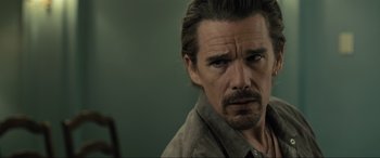 Movie still from “Raymond & Ray” (2022), directed by Rodrigo García – A person wearing a shirt; Close Up shot, Over the shoulder angle