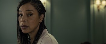 Movie still from “Raymond & Ray” (2022), directed by Rodrigo García – A person with braids looking at the camera; Close Up shot, Over the shoulder angle