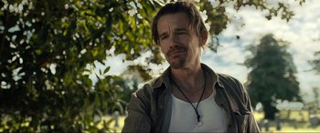 Movie still from “Raymond & Ray” (2022), directed by Rodrigo García – A person wearing a necklace; Close Up shot, Over the shoulder angle