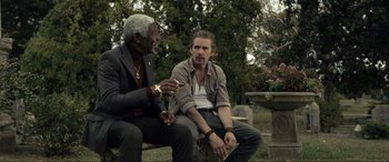 Movie still from “Raymond & Ray” (2022), directed by Rodrigo García – Two men sitting on a bench in a cemetery; Medium shot, Over the shoulder angle