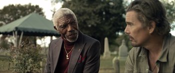 Movie still from “Raymond & Ray” (2022), directed by Rodrigo García – An older man in a suit and a red tie; Close Up shot, Low angle