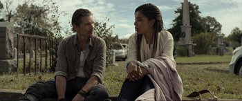 Movie still from “Raymond & Ray” (2022), directed by Rodrigo García – A man and a woman sitting on the grass; Medium shot, Over the shoulder angle