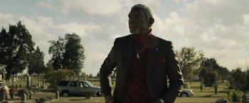 Movie still from “Raymond & Ray” (2022), directed by Rodrigo García – An older man wearing a suit and tie; Medium shot, Low angle