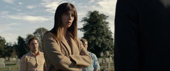 Movie still from “Raymond & Ray” (2022), directed by Rodrigo García – A woman standing with her arms crossed in front of a tree; Medium shot, Over the shoulder angle