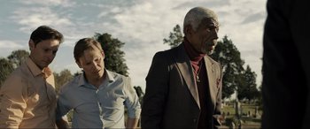 Movie still from “Raymond & Ray” (2022), directed by Rodrigo García – Two men are walking in a park together; Medium shot, Low angle