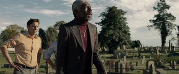 Movie still from “Raymond & Ray” (2022), directed by Rodrigo García – An older man wearing a suit and a red tie; Medium shot, Low angle