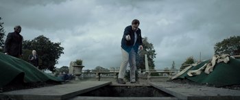 Movie still from “Raymond & Ray” (2022), directed by Rodrigo García – A man standing on top of a cement platform; Wide shot, Low angle
