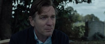 Movie still from “Raymond & Ray” (2022), directed by Rodrigo García – A person wearing a jacket looking at the camera; Close Up shot, Over the shoulder angle