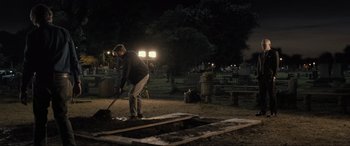 Movie still from “Raymond & Ray” (2022), directed by Rodrigo García – A man is digging a hole in the ground at night; Wide shot, High angle