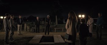 Movie still from “Raymond & Ray” (2022), directed by Rodrigo García – Two men and a woman standing in front of an empty grave; Wide shot, High angle