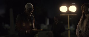 Movie still from “Raymond & Ray” (2022), directed by Rodrigo García – An older man holding a piece of paper in his hands; Medium shot, Low angle