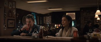 Movie still from “Raymond & Ray” (2022), directed by Rodrigo García – A man and a woman sitting at a table in a restaurant; Medium shot, Over the shoulder angle