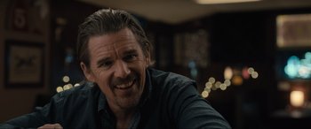 Movie still from “Raymond & Ray” (2022), directed by Rodrigo García – A person smiling for the camera; Close Up shot, Over the shoulder angle