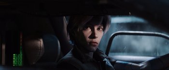 Movie still from “Ready Player One” (2018), directed by Steven Spielberg – A young man sitting in the back seat of a car; Close Up shot, Over the shoulder angle