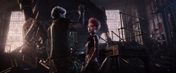 Movie still from “Ready Player One” (2018), directed by Steven Spielberg – A man and a woman are standing in an industrial setting; Medium shot, Over the shoulder angle