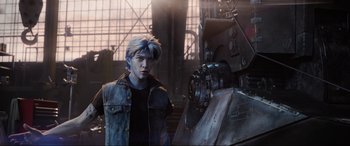 Movie still from “Ready Player One” (2018), directed by Steven Spielberg – A man standing in front of a camera in an industrial setting; Medium shot, Low angle