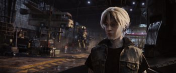 Movie still from “Ready Player One” (2018), directed by Steven Spielberg – A man in a black jacket standing in a room; Medium shot, Over the shoulder angle