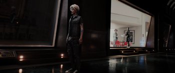 Movie still from “Ready Player One” (2018), directed by Steven Spielberg – A man standing in front of a mirror in a room; Wide shot, Over the shoulder angle