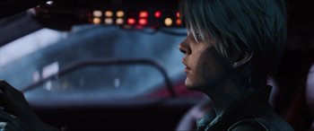 Movie still from “Ready Player One” (2018), directed by Steven Spielberg – A person with a face paint sitting in a car; Close Up shot, Over the shoulder angle