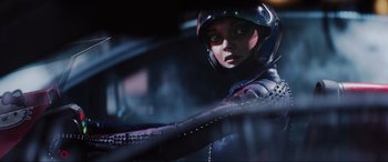 Movie still from “Ready Player One” (2018), directed by Steven Spielberg – A woman in a helmet is sitting in a car; Close Up shot, Over the shoulder angle