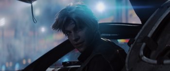 Movie still from “Ready Player One” (2018), directed by Steven Spielberg – A young man with blonde spiky hair sitting in a car; Close Up shot, Over the shoulder angle