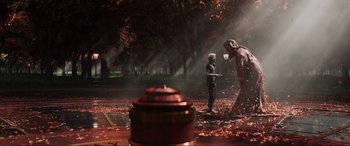 Movie still from “Ready Player One” (2018), directed by Steven Spielberg – Two people are standing in the leaves near a fire hydrant; Extreme Wide shot, Over the shoulder angle