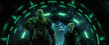 Movie still from “Ready Player One” (2018), directed by Steven Spielberg – A man and a woman standing inside of a building; Medium shot, Low angle