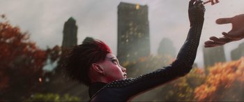 Movie still from “Ready Player One” (2018), directed by Steven Spielberg – A woman with a mohawk hair style in front of a city; Close Up shot, Low angle