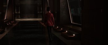 Movie still from “Ready Player One” (2018), directed by Steven Spielberg – A person walking in a dark room with candles; Wide shot, High angle