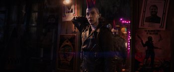 Movie still from “Ready Player One” (2018), directed by Steven Spielberg – A person wearing a leather jacket and a party hat; Medium shot, Over the shoulder angle