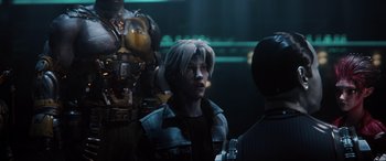 Movie still from “Ready Player One” (2018), directed by Steven Spielberg – A man in a black jacket is talking to two other men; Close Up shot, Over the shoulder angle