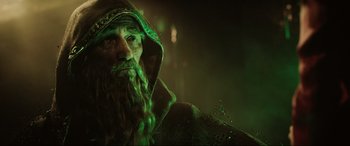 Movie still from “Ready Player One” (2018), directed by Steven Spielberg – A man with long hair and a beard wearing a green hood; Close Up shot, Low angle