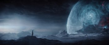 Movie still from “Ready Player One” (2018), directed by Steven Spielberg – A man standing in front of a large waterfall; Extreme Wide shot, Low angle