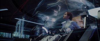 Movie still from “Ready Player One” (2018), directed by Steven Spielberg – A woman sitting in a chair in front of a computer screen; Medium shot, High angle
