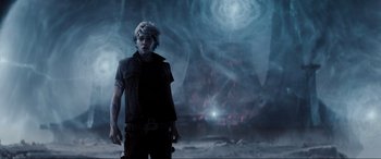 Movie still from “Ready Player One” (2018), directed by Steven Spielberg – A man standing in front of an exploding building; Medium shot, Over the shoulder angle