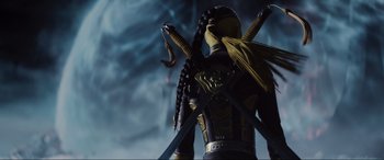 Movie still from “Ready Player One” (2018), directed by Steven Spielberg – A toy figure holding two swords; Medium shot, Low angle