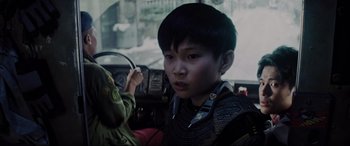 Movie still from “Ready Player One” (2018), directed by Steven Spielberg – A young boy sitting in the driver's seat of a car; Close Up shot, Over the shoulder angle