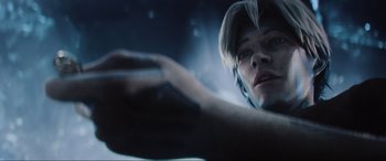 Movie still from “Ready Player One” (2018), directed by Steven Spielberg – A man is holding something in his hand; Close Up shot, Low angle