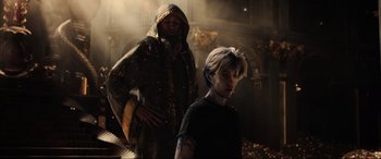 Movie still from “Ready Player One” (2018), directed by Steven Spielberg – A man and a woman standing next to each other in a dark room; Medium shot, Low angle