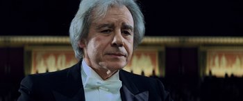 Movie still from “Red Dragon” (2002), directed by Brett Ratner – An older man wearing a tuxedo and a bow tie; Close Up shot, Low angle