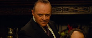 Movie still from “Red Dragon” (2002), directed by Brett Ratner – A person wearing a suit and tie; Close Up shot, Over the shoulder angle