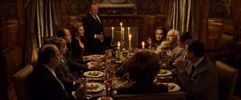 Movie still from “Red Dragon” (2002), directed by Brett Ratner – A group of people sitting around a dinner table; Medium shot, Over the shoulder angle