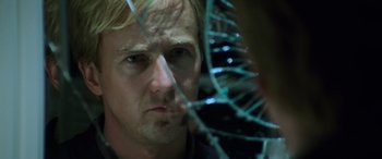 Movie still from “Red Dragon” (2002), directed by Brett Ratner – A person looking through a broken glass window; Close Up shot, Over the shoulder angle