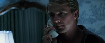 Movie still from “Red Dragon” (2002), directed by Brett Ratner – A person talking on a phone; Close Up shot, Low angle